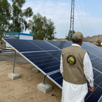 workers assembling solar panels